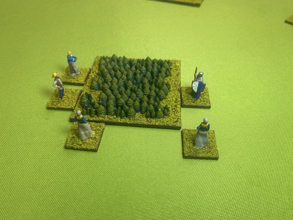 Villagers harvesting wood from a forest on the tabletop Swords and Stones