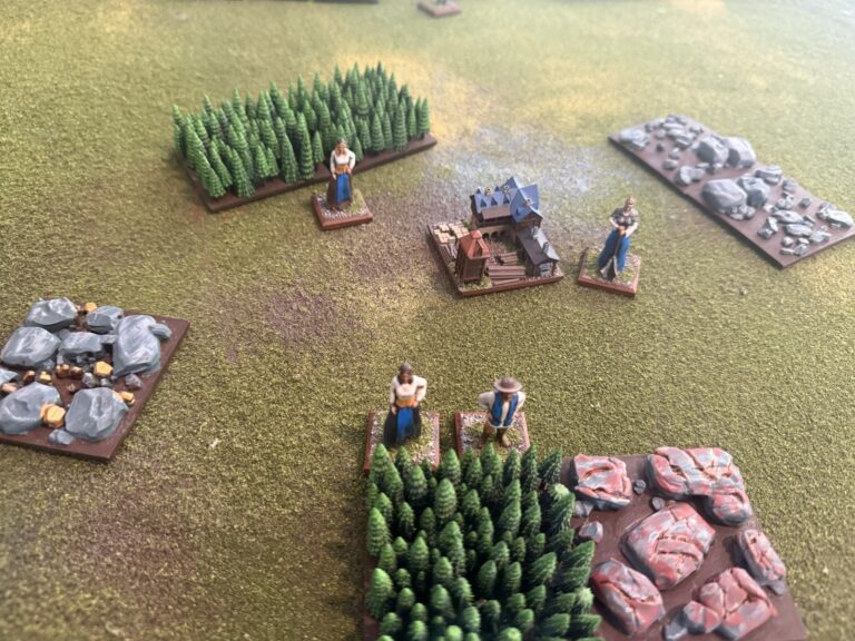 Stockpile and villagers starting to harvest resources
